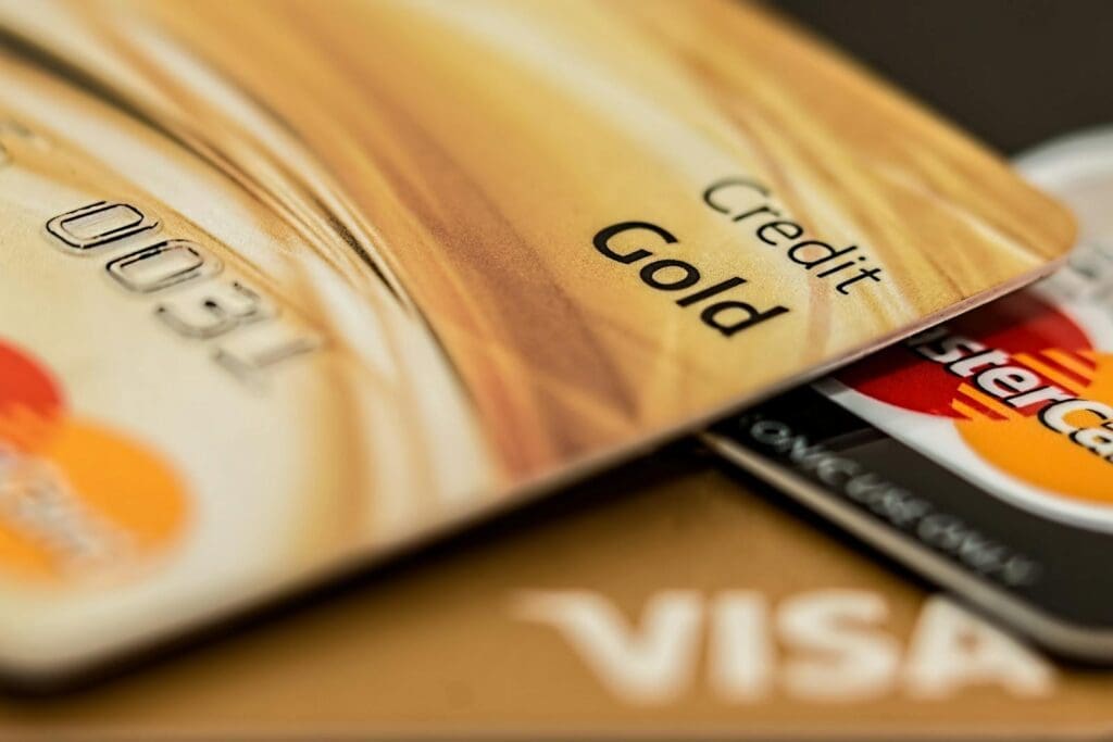 Stack of various branded credit cards focusing on gold card showing credit card payment journey